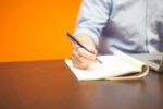 Professional writing a clear email at a laptop workspace