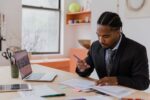 Professional signing resignation documents at office desk