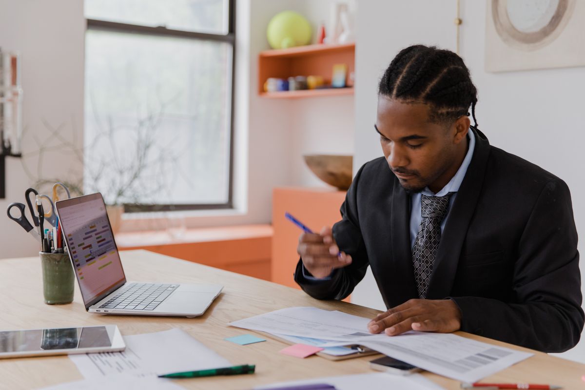 Professional signing resignation documents at office desk