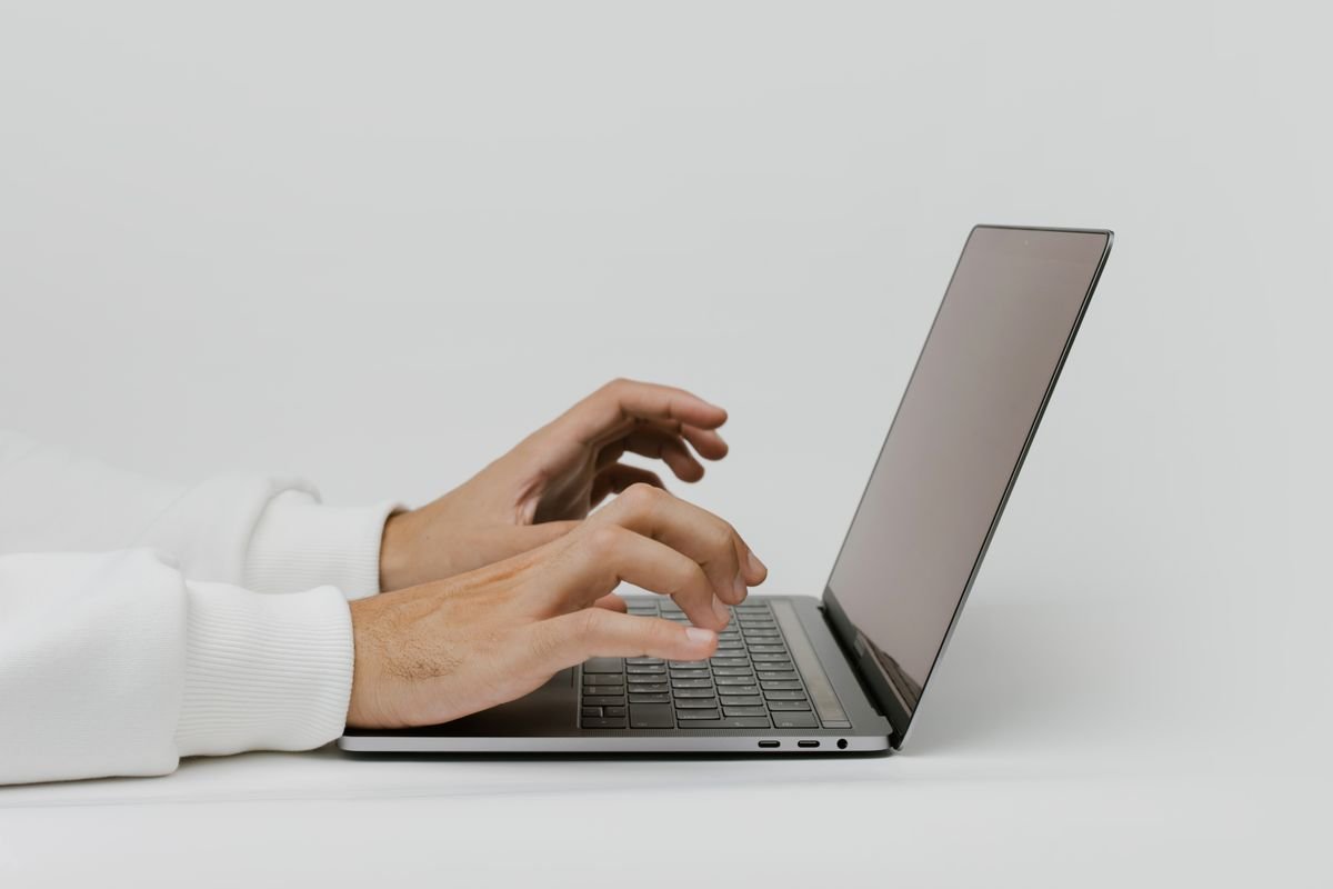 Person typing on a laptop at an office desk