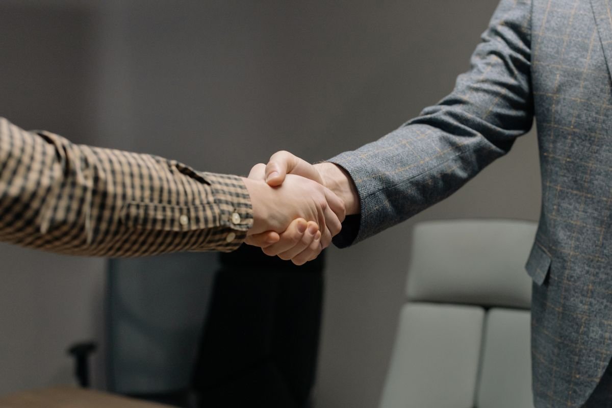Two professionals shaking hands after a successful interview