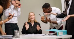 Team having a conversation in an office, representing career transitions and job hopping decisions
