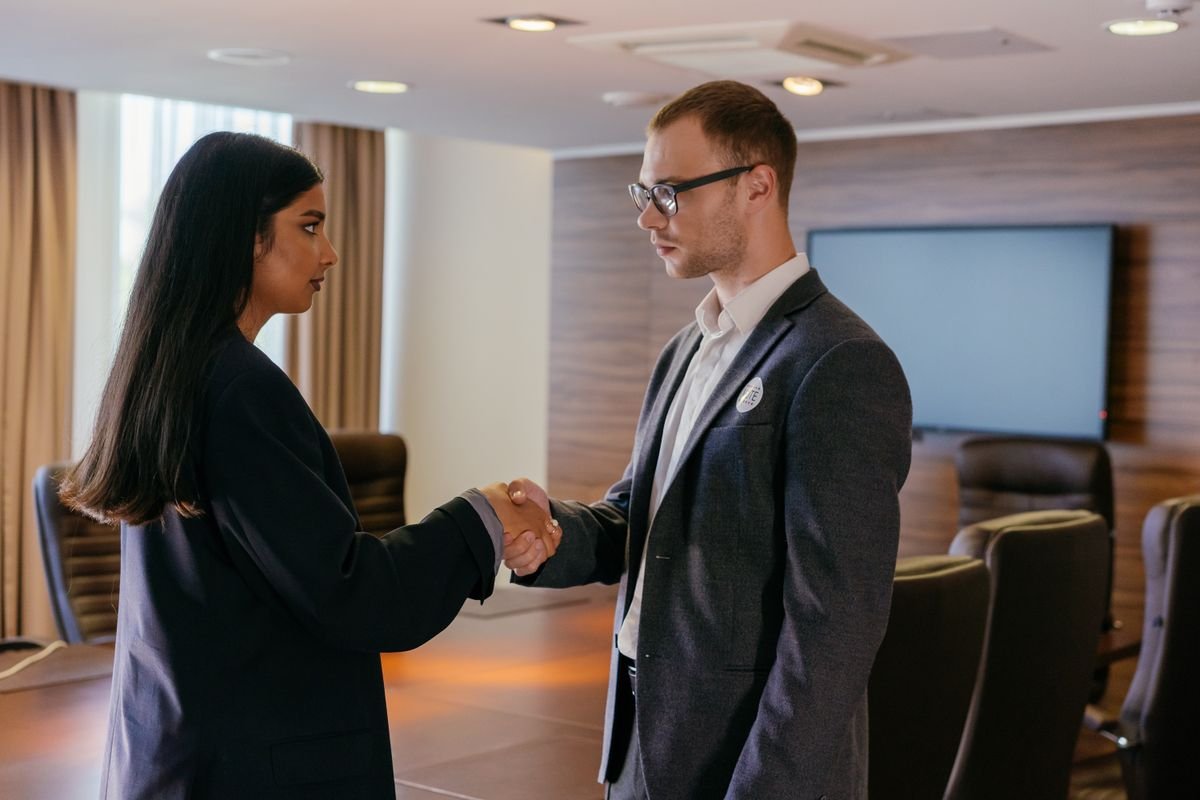 Job offer negotiation handshake in a modern office