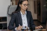 Young employee working at desk during probation period at a new job