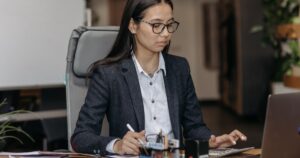 Young employee working at desk during probation period at a new job