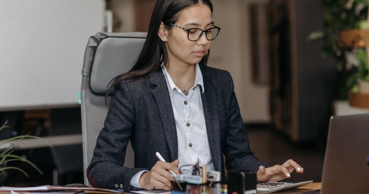 Young employee working at desk during probation period at a new job